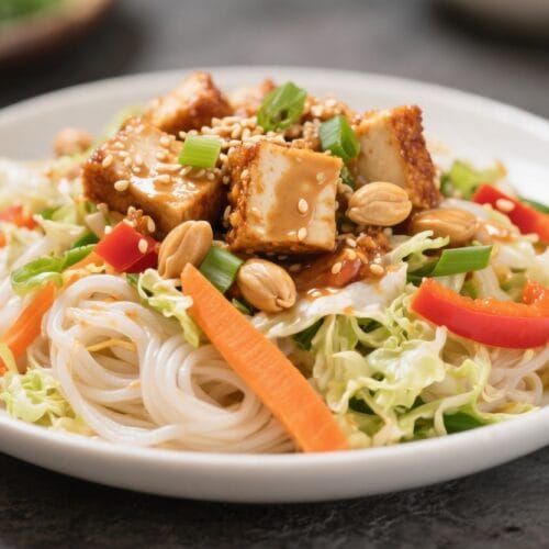 Vibrant Vegan Noodle Bowl: Fresh rice noodles, crunchy veggies, tofu & peanuts for a healthy lunch. Save this idea so you can come back to it later.
