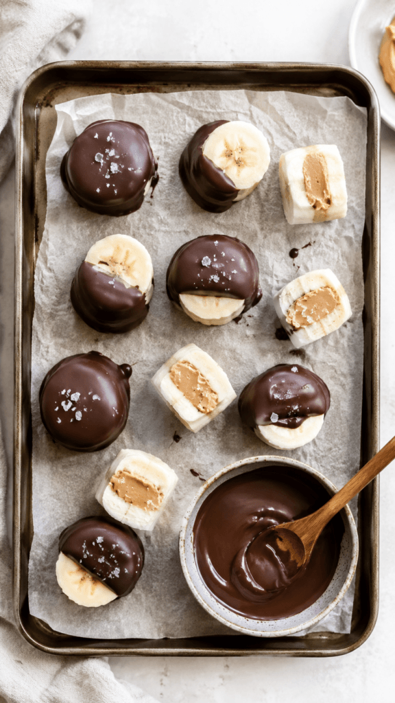 Frozen Banana Bites Magic: Indulgent, snackable treats—peanut butter bananas half-dipped in chocolate. Easy, healthy dessert—Save this idea so you can come back to it later.