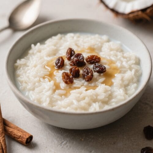 Creamy Rice Pudding Delight: Lush rice pudding with plump raisins, honey drizzle, and warm spices—ideal comfort food. Save this idea so you can come back to it later.